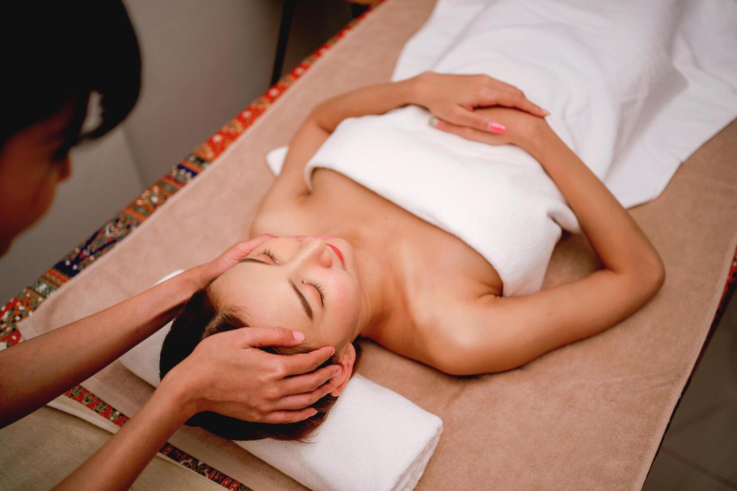 woman is getting a massage on a table free photo
